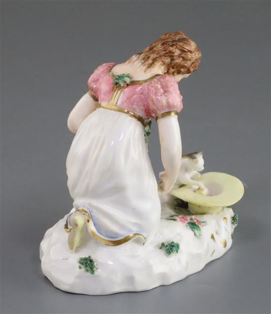 A Rockingham porcelain group of a kneeling girl playing with a kitten, c.1830, h. 10.5cm, small losses